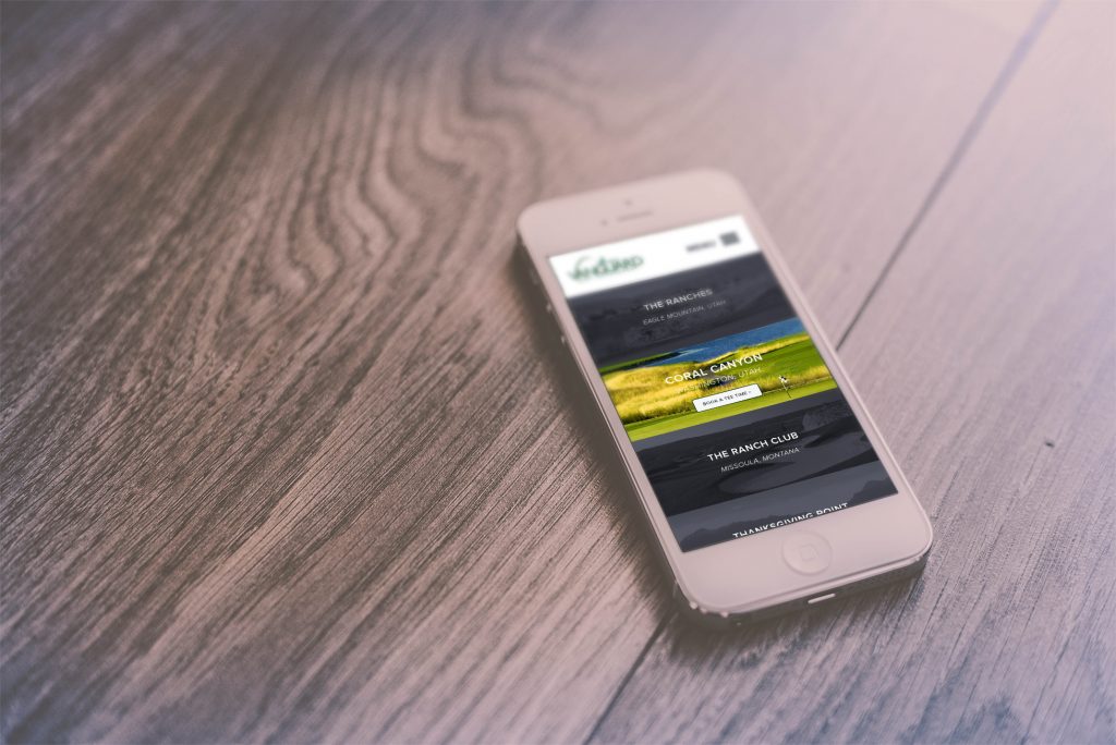 vanguard golf homepage on iphone 6, sitting on wood table
