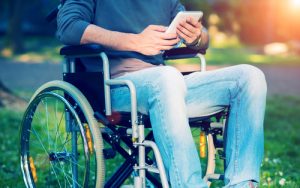 Man in wheelchair using a tablet