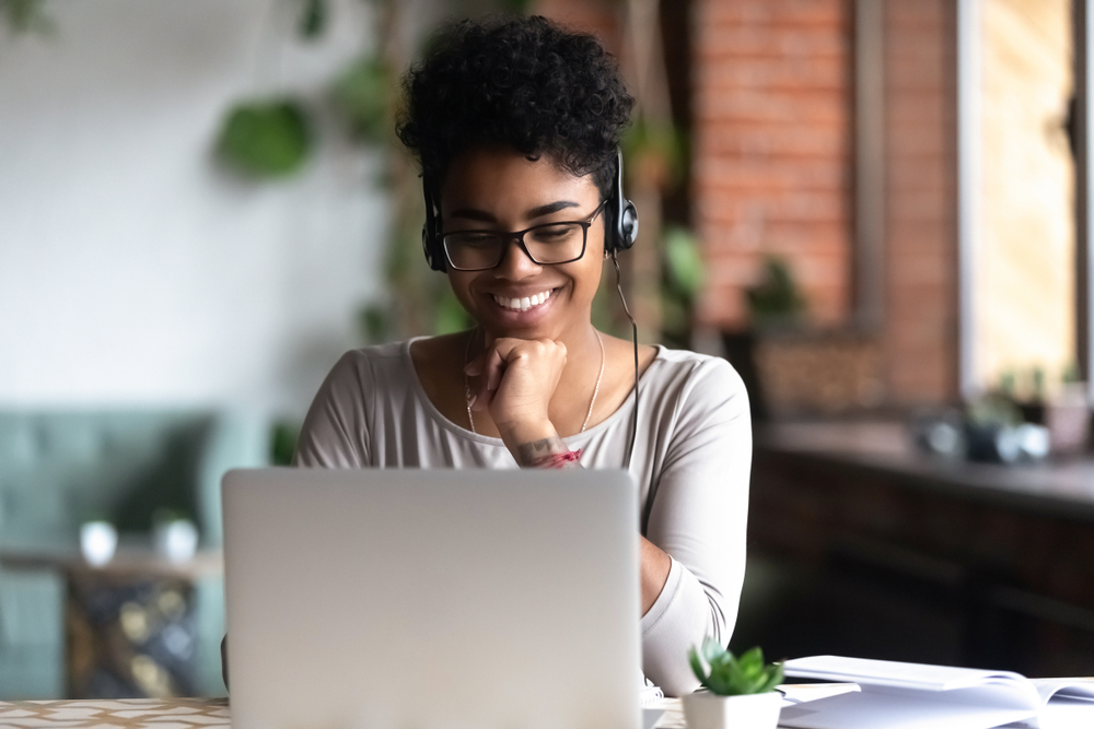 woman smiling with computer